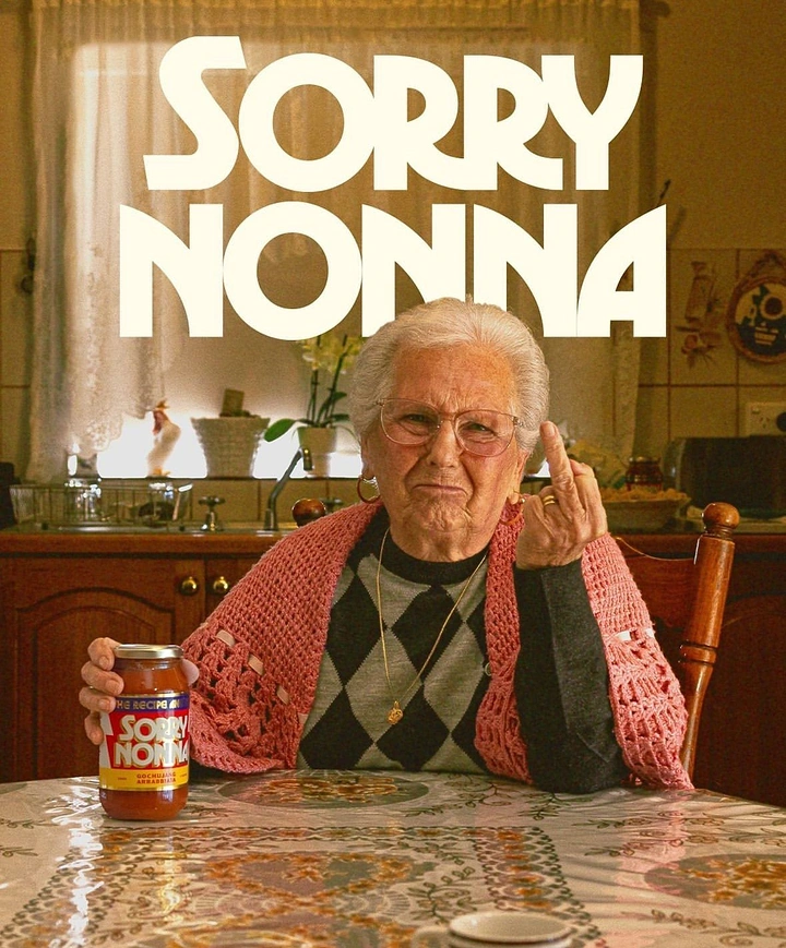 Food & Beverage creative ad: Grumpy Italian grandmother flipping the bird while holding a pasta sauce jar