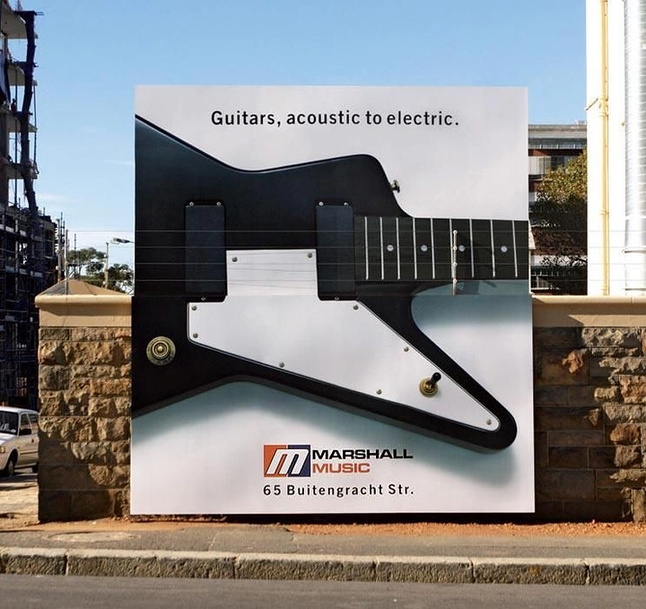 Musical Instrument Stores creative ad: Giant electric guitar body with real strings on billboard