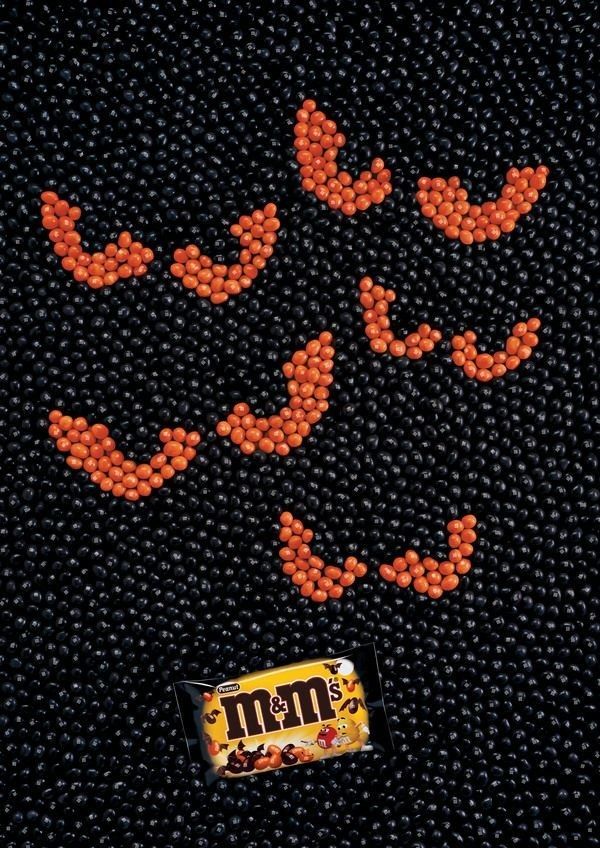 Orange candies arranged as bat shapes on a field of black candies