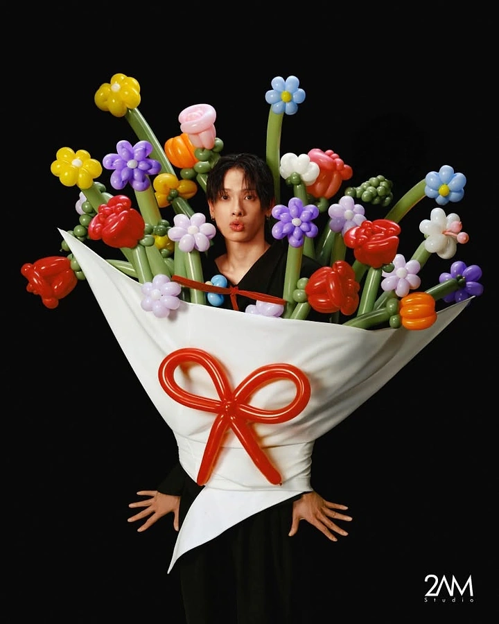 Balloon & Party Decorators creative ad: Man wearing a giant balloon-flower bouquet costume