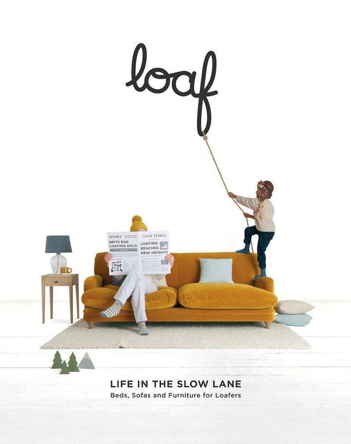 Home Decor creative ad: Person reading newspaper on mustard velvet sofa while a child climbs a rope to the logo