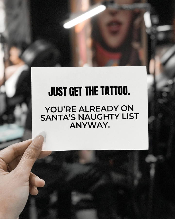 Tattoo Studios creative ad: Witty Santa naughty-list copy on handheld card