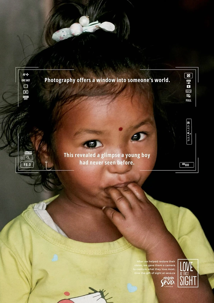Creative ad: Close-up portrait of a young girl framed by a camera viewfinder HUD