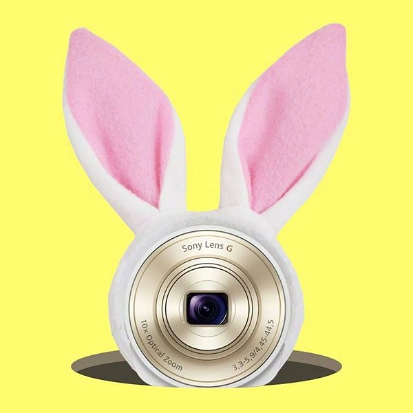 Easter creative ad: Camera lens wearing plush bunny ears popping out of a hole