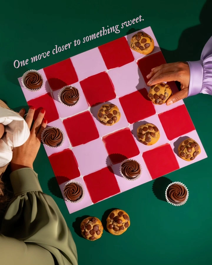Creative ad: Top-down checkers game played with cookies and cupcakes
