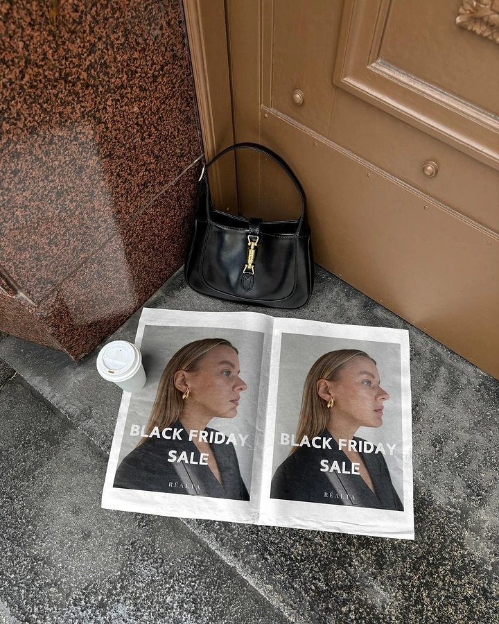 Black Friday creative ad: Newspaper-style sale print on a doorstep beside a handbag