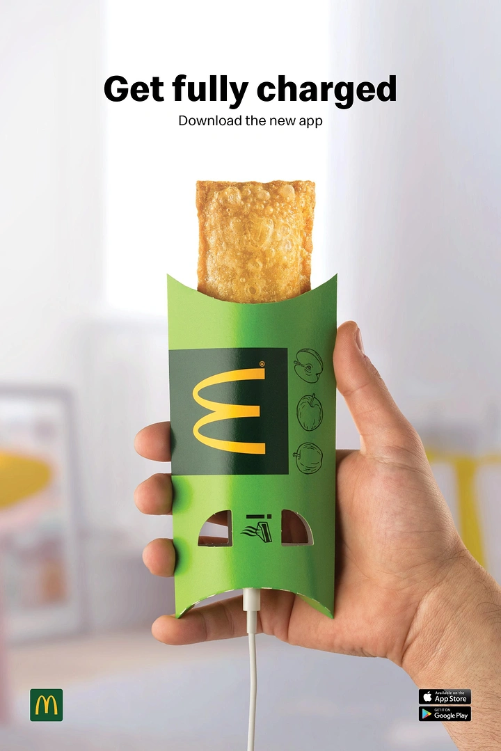 IT & Software creative ad: Hand holding an apple pie sleeve with a charging cable plugged in like a phone
