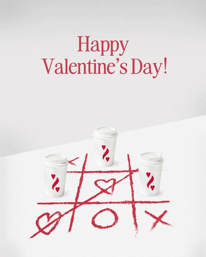 Valentine's Day creative ad: Three branded coffee cups on a lipstick-drawn tic-tac-toe grid