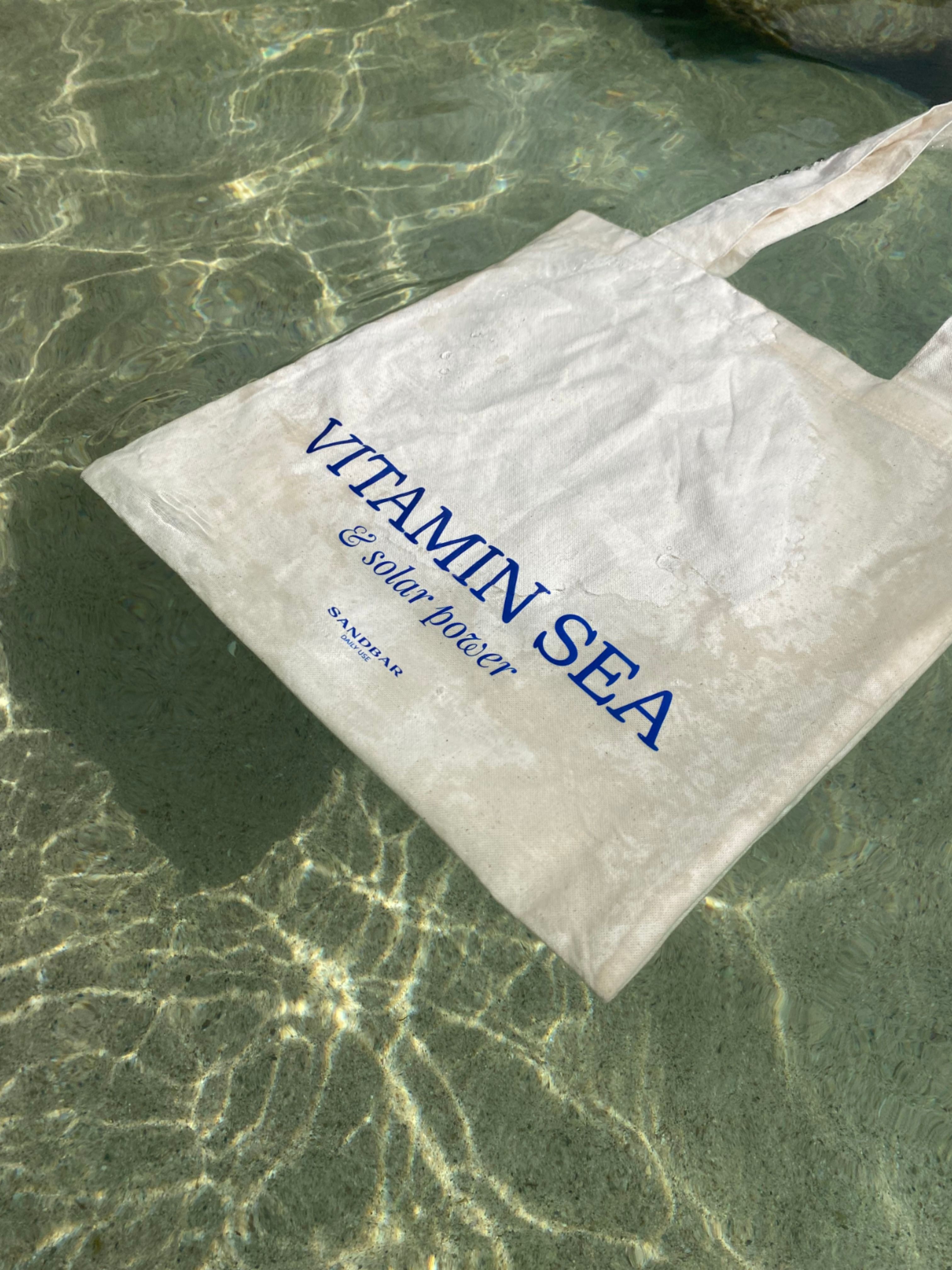 Instagram post: Vitamin Sea pun with tote in water, slide 2