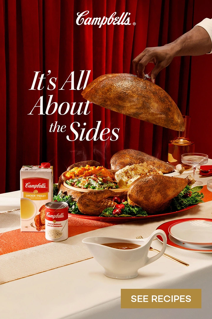 Thanksgiving creative ad: Hand lifting a turkey-shaped cloche to reveal a platter of holiday sides