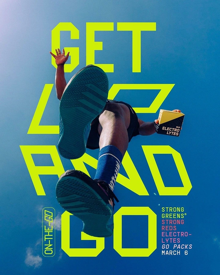 Wellness & Ayurveda creative ad: Low-angle athlete leaping overhead holding an electrolytes box
