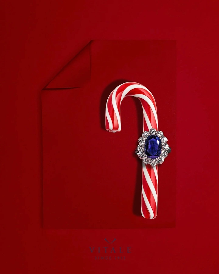 Christmas creative ad: Sapphire halo ring slipped onto a candy cane