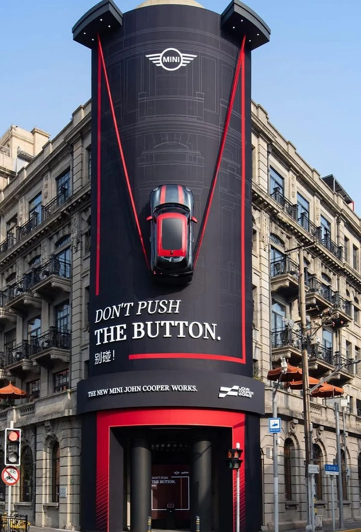 Automotive creative ad: Real hot hatch mounted nose-down on a black wrapped corner tower