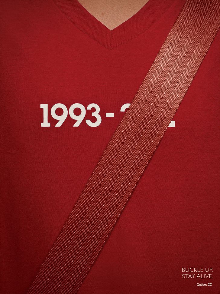 Poster: Seatbelt across a red V-neck t-shirt, covering the end of a printed date range
