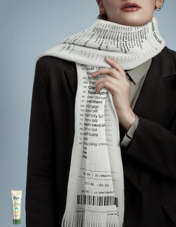 Skincare & Cosmetics creative ad: Model wearing a knitted scarf printed like a long shopping receipt of bills and debts