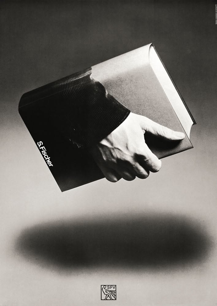 A hand in a knit sleeve reaching out of a floating book's cover
