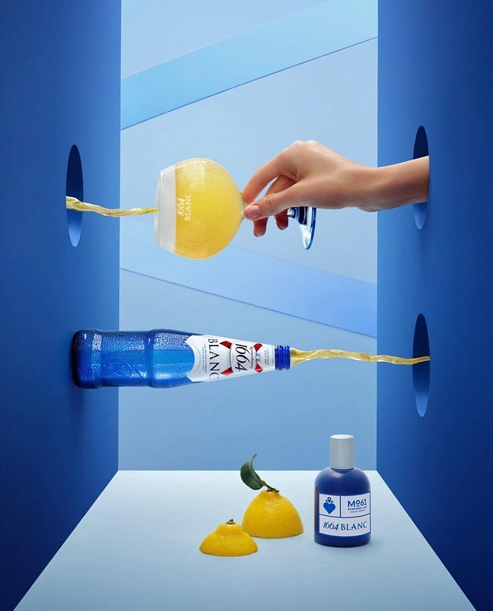 Beer, Wine & Spirits creative ad: Beer poured through wall holes into a glass beside a collab perfume bottle