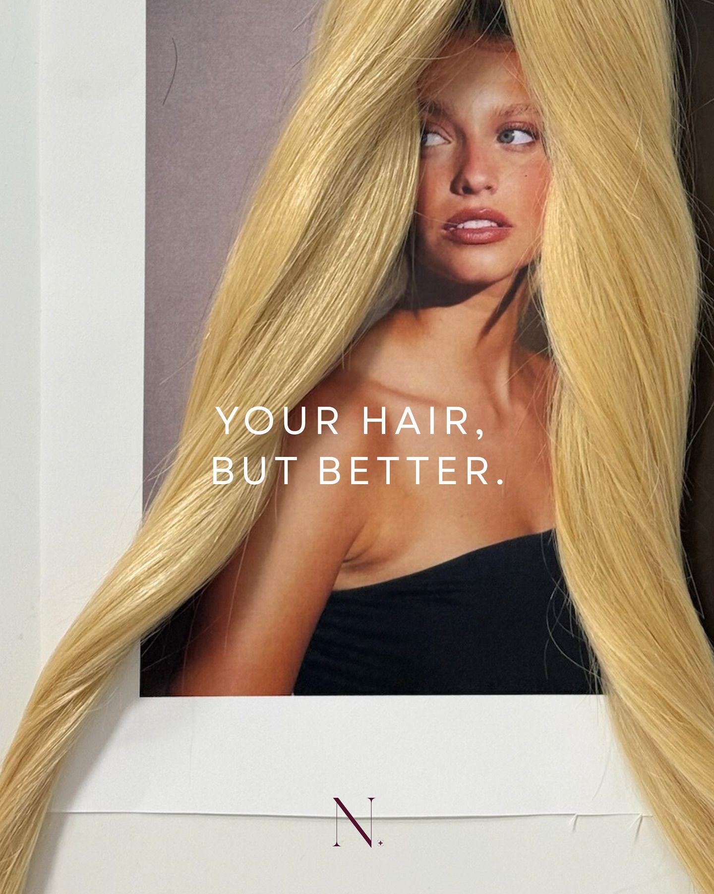 Instagram post: Real blonde hair wefts draped over a printed portrait of a model