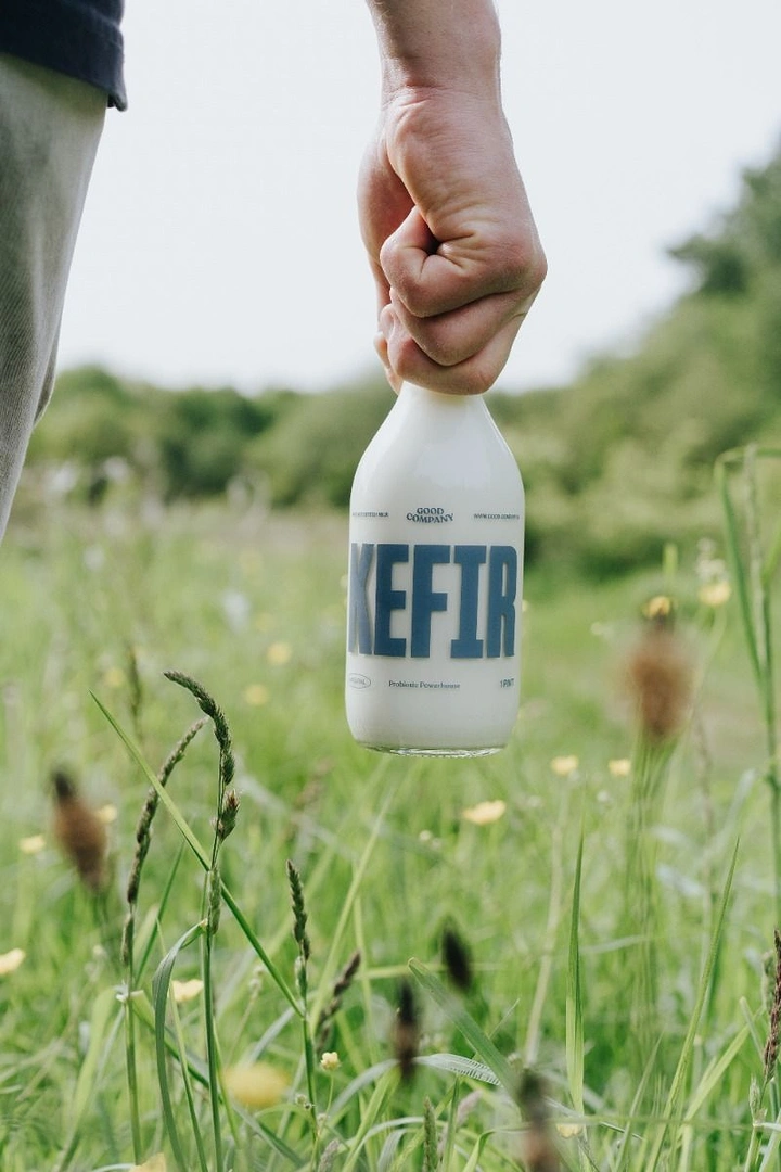 Dairy Brands creative ad: Kefir bottle carried through meadow, fresh origin