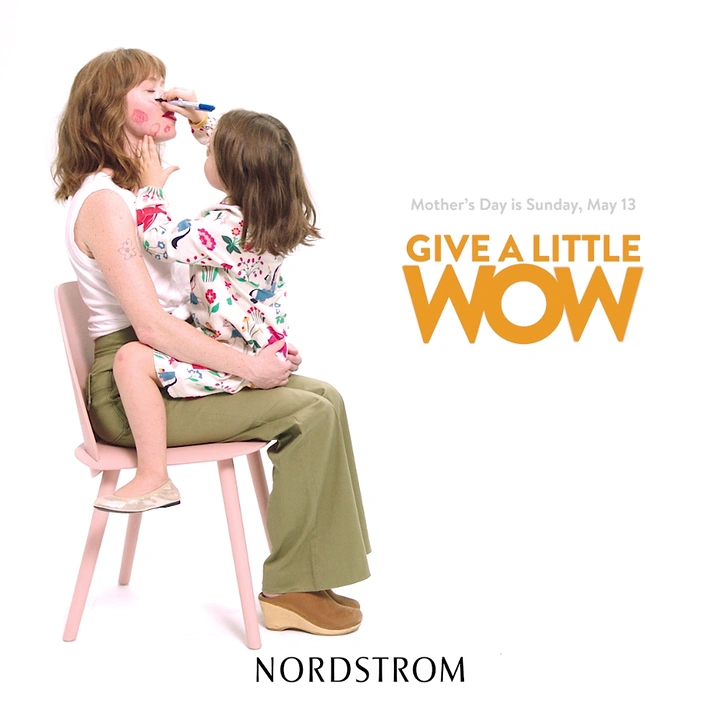 Mother's Day creative ad: Toddler drawing on mother's face while sitting on her lap