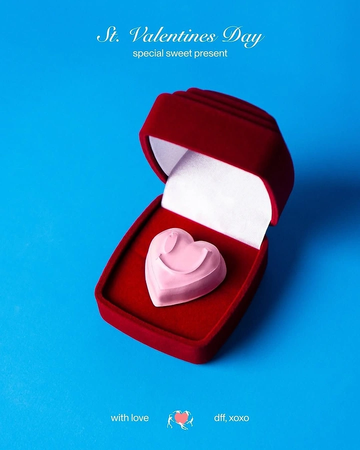 Valentine's Day creative ad: Pink smiley heart sweet inside an open red velvet ring box