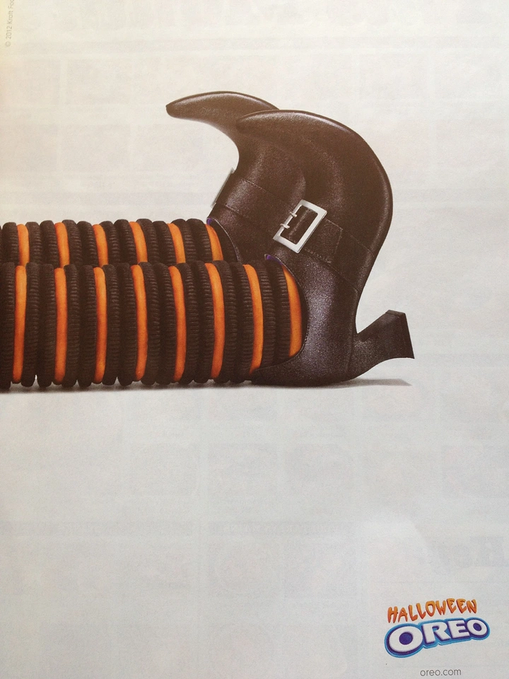 Halloween creative ad: Stacked orange-cream cookies as witch legs in boots