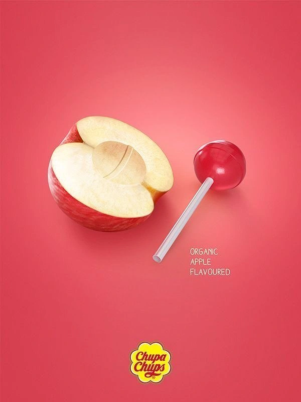 Sweet Shop creative ad: Halved apple with a lollipop-shaped hollow next to a red lollipop