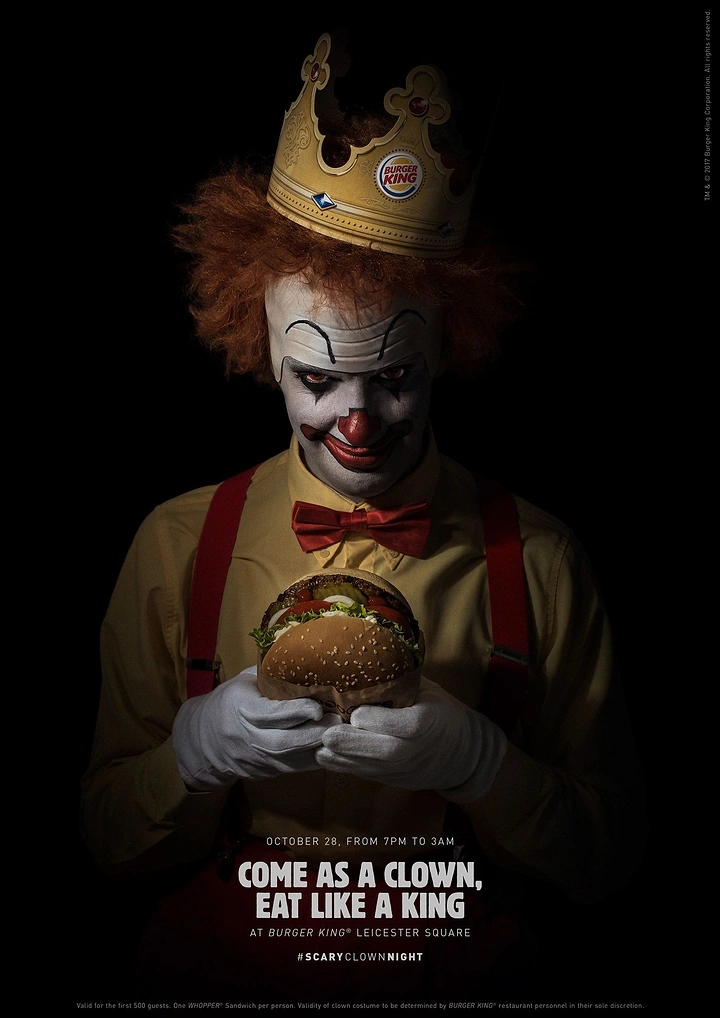 Halloween creative ad: Sinister clown in crown holding a burger