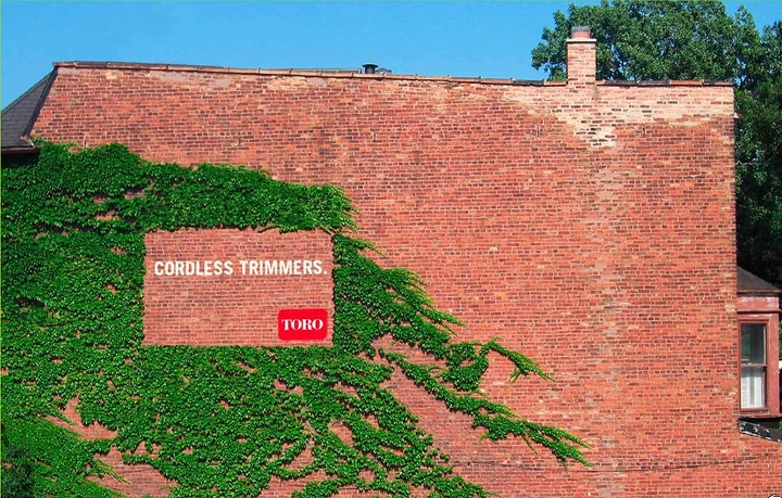 Hardware Stores creative ad: Ivy-covered brick wall with a neatly trimmed rectangle used as a billboard
