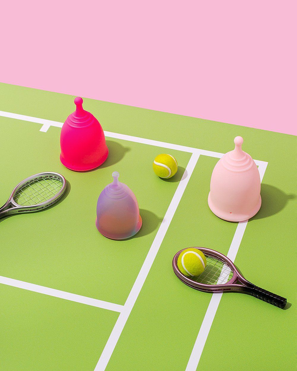 Instagram post: Menstrual cups on a miniature tennis court