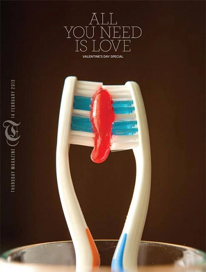 Valentine's Day creative ad: Two toothbrushes bristle-to-bristle sharing a red dab of toothpaste