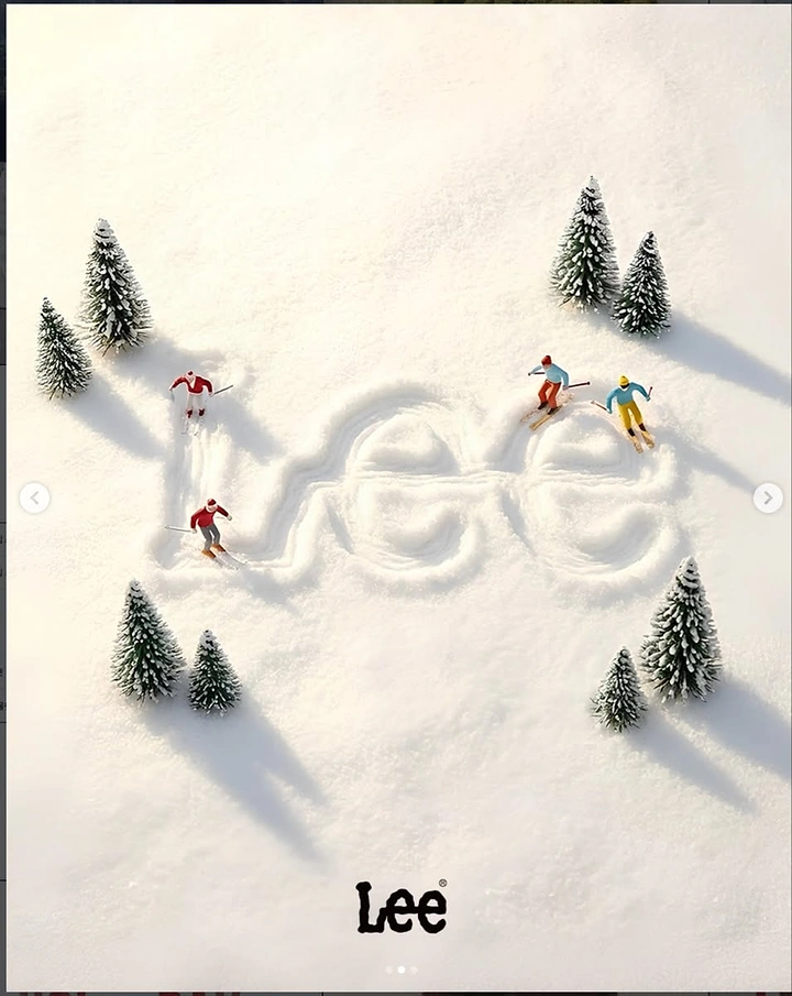 Christmas creative ad: Miniature skiers carving a brand logo into fresh snow