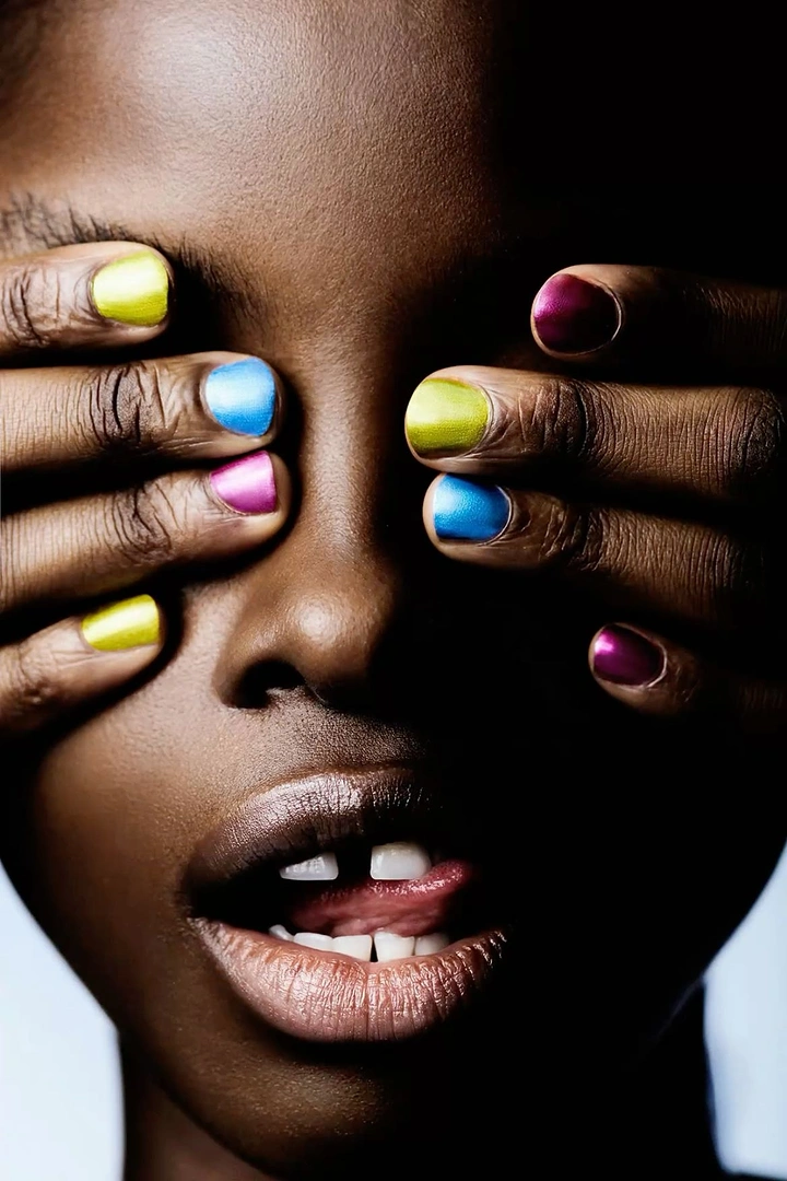 Nail Polish Brands creative ad: Surreal face framed by colorful nails