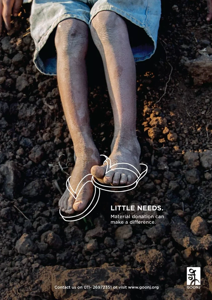Creative ad: Child's bare feet on dry soil with drawn-on white outline slippers