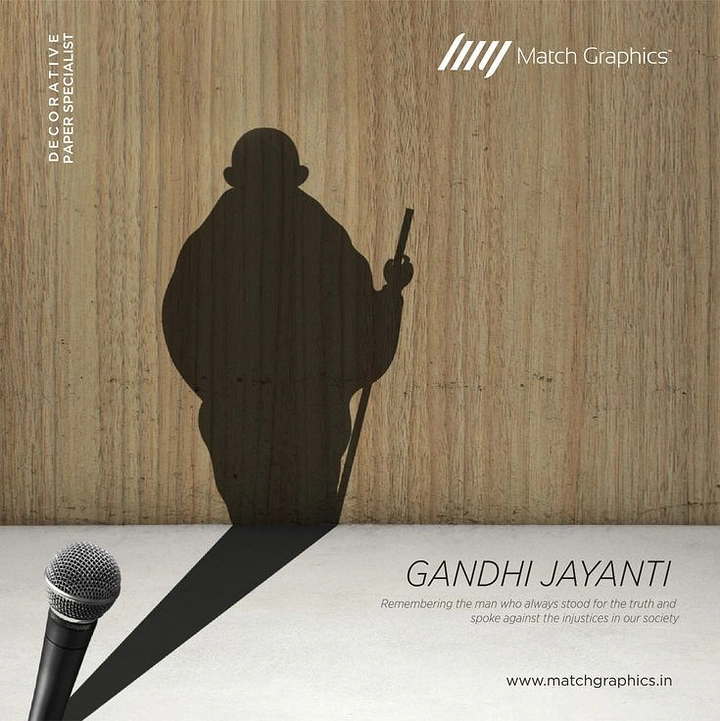 Gandhi Jayanti creative ad: A microphone casting Gandhi's silhouette shadow on a wood-grain wall