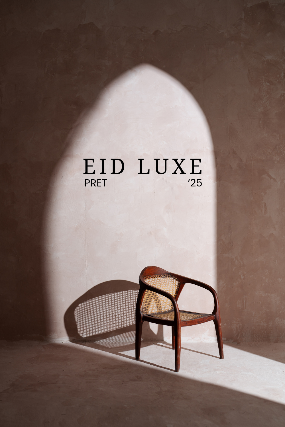 Eid Instagram post: Lone cane-back wooden chair in a pointed-arch beam of sunlight