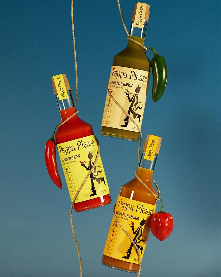 Sauces & Condiments creative ad: Three hot sauce bottles suspended by twine with chillies
