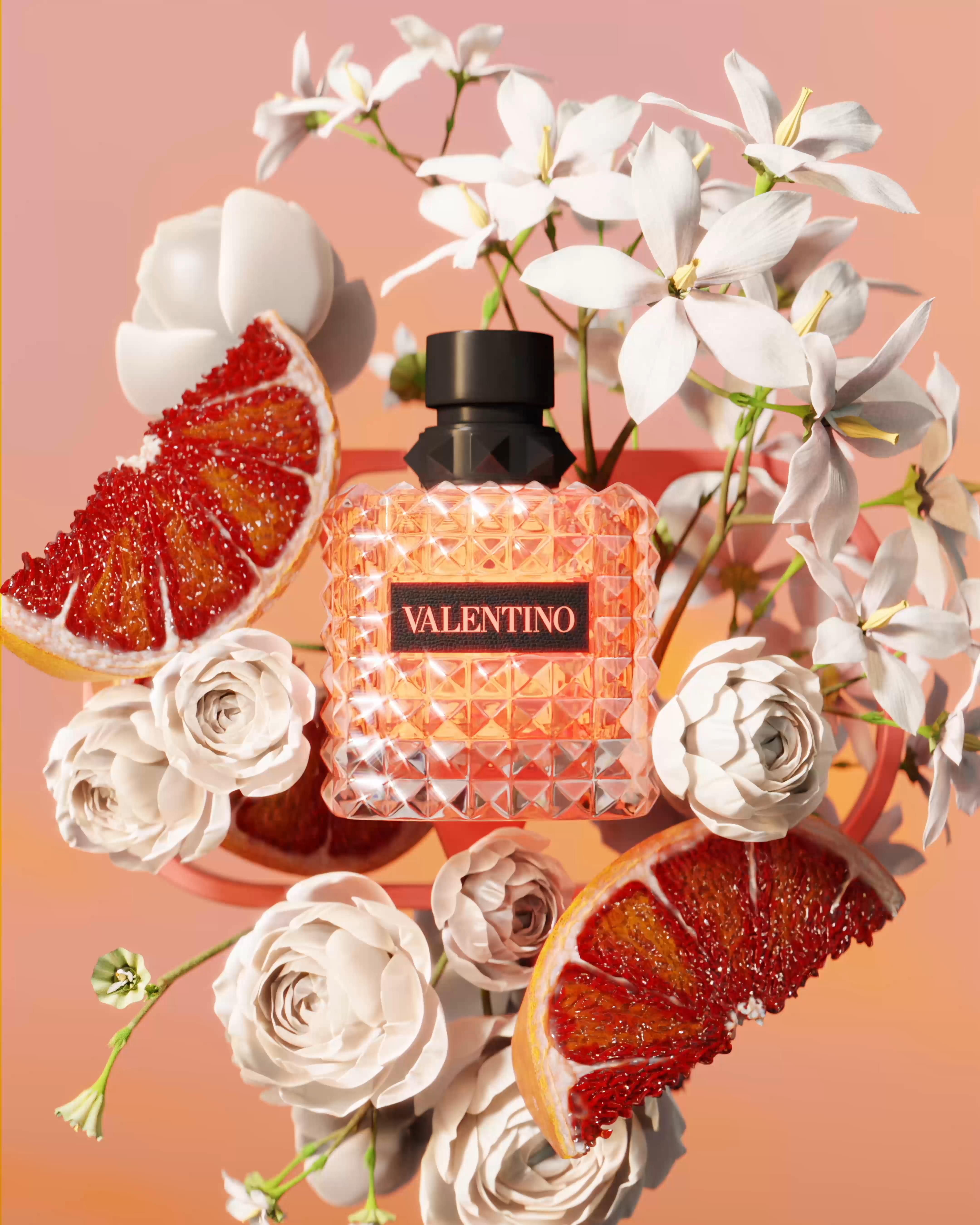 Instagram post: Studded coral perfume bottle among flowers and blood orange