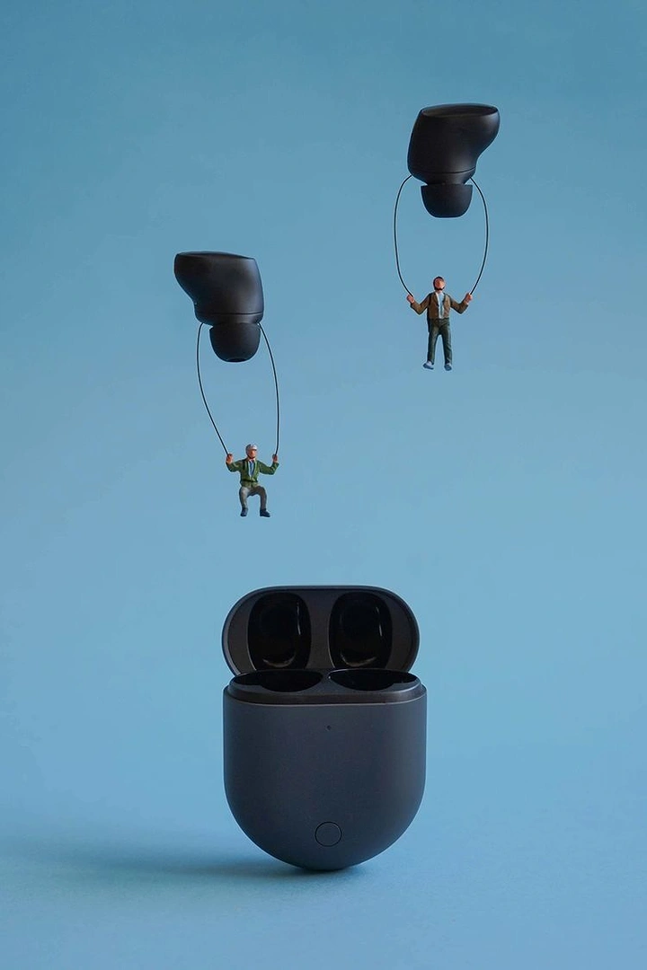 Headphones & Speakers creative ad: People suspended from earbuds metaphor