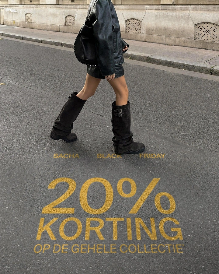 Black Friday creative ad: Woman in black leather walking across asphalt in slouchy boots