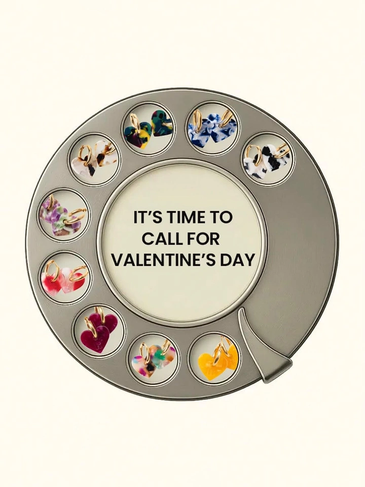 Valentine's Day creative ad: Rotary phone dial with heart earrings in its finger holes