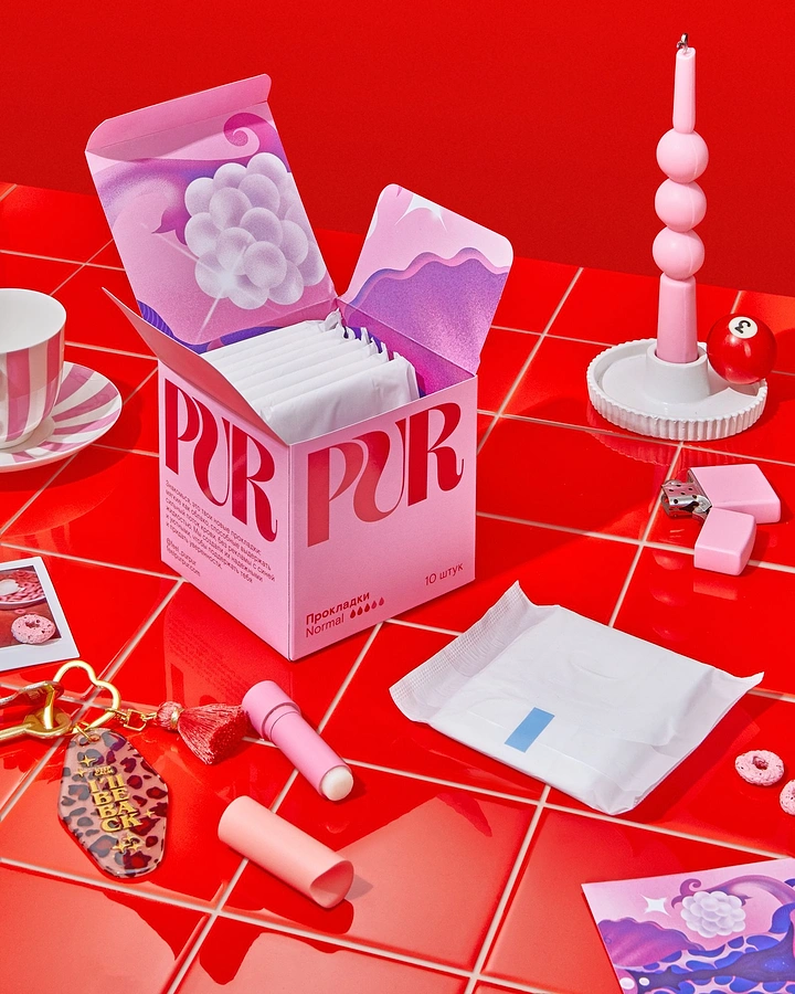 Period Care & Feminine Hygiene creative ad: Open pink pad box on glossy red tiled table