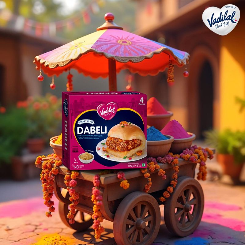 Holi Instagram post: Frozen dabeli box on a decorated wooden street cart