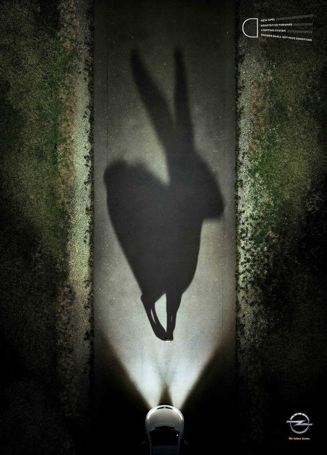 Poster: Tiny hare casting a giant shadow in car headlights