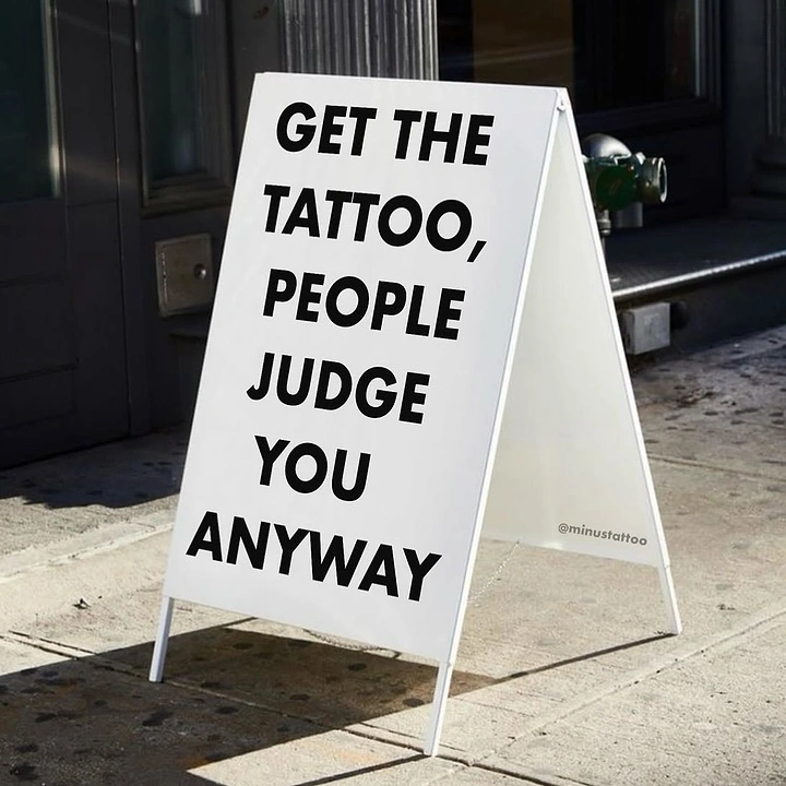 Tattoo Studios creative ad: Cheeky sidewalk-sign copy: people judge anyway