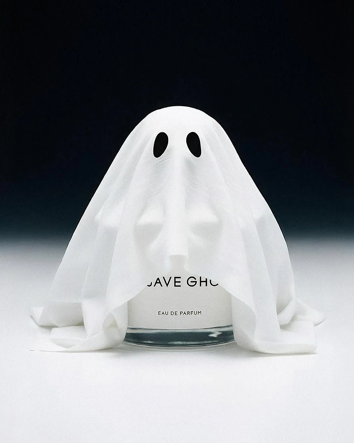 Halloween creative ad: Perfume bottle draped in a white sheet ghost costume