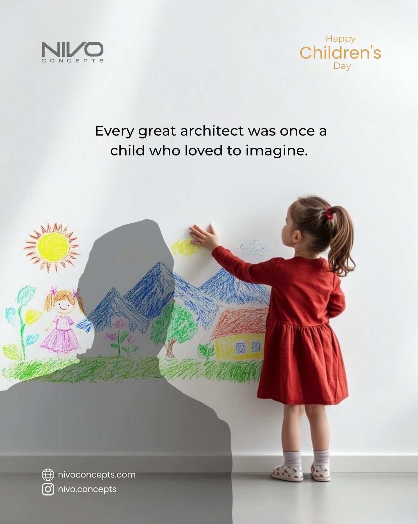 Little girl drawing crayon landscape on white wall beside adult shadow