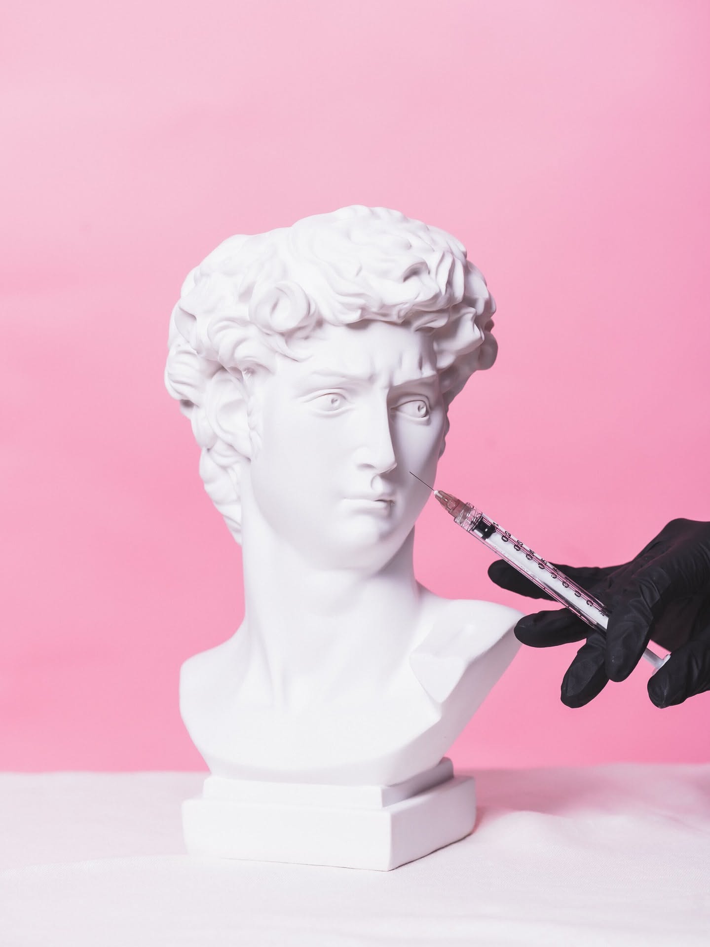 Instagram post: Classical bust turned into injection metaphor