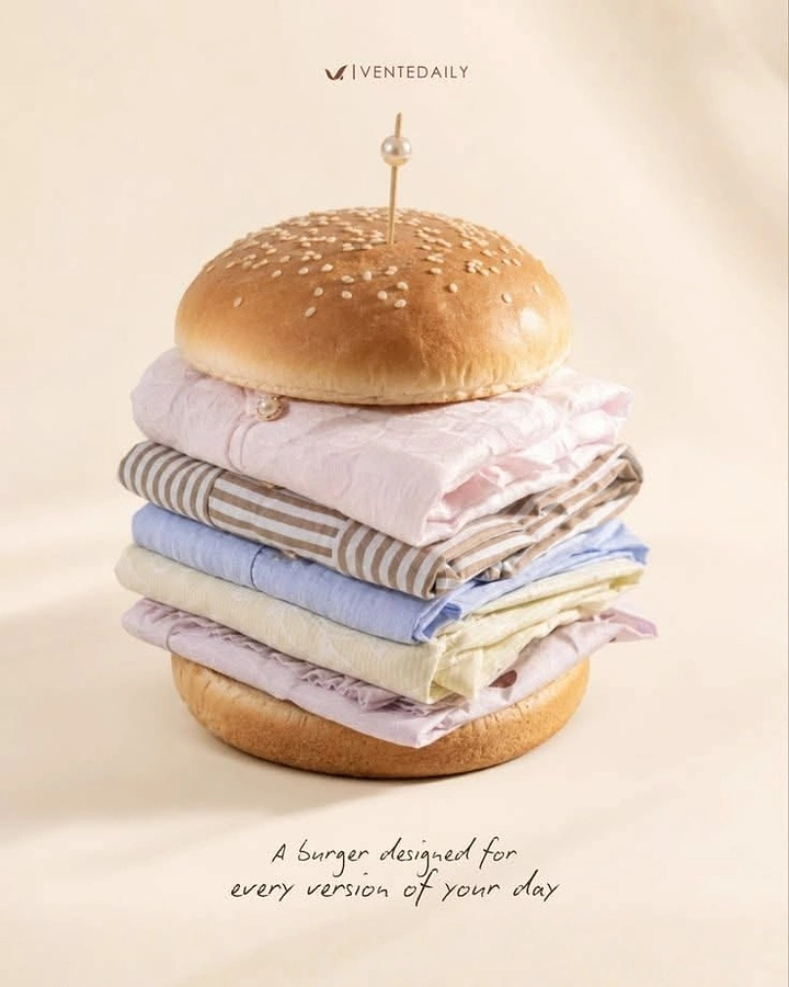 Fashion creative ad: Burger made of folded pastel shirts between sesame buns