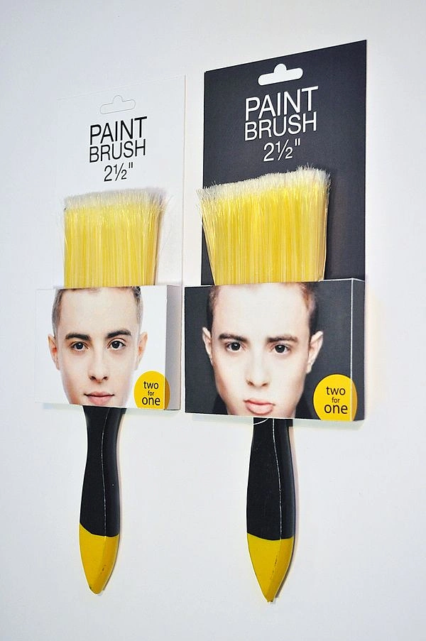 Hardware Stores creative ad: Two paintbrushes packaged as human faces with bristles replacing hair